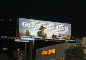 Godless Netflix illuminated billboard advertising at night in Los Angeles