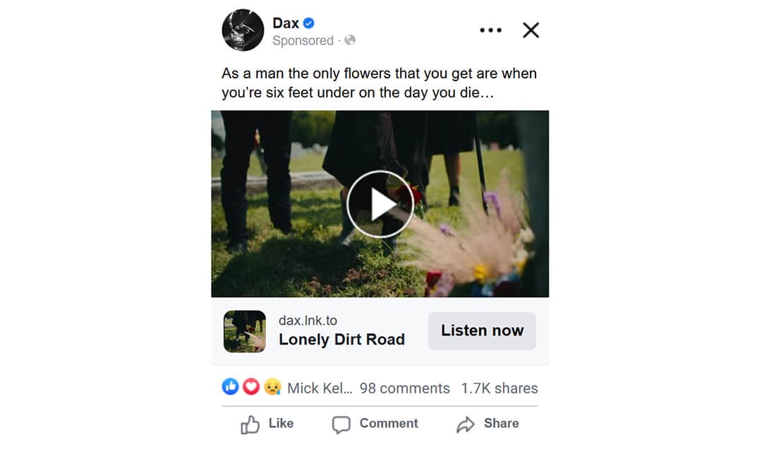 A Facebook ad for Dax’s song Lonely Dirt Road, showing a video thumbnail of people standing by a gravesite with flowers. The caption reads, “As a man the only flowers that you get are when you’re six feet under on the day you die…”.