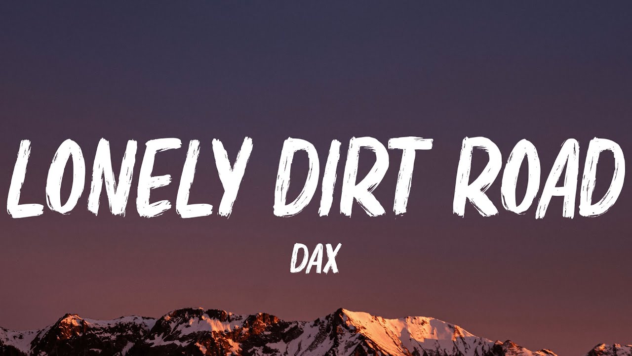 Text LONELY DIRT ROAD and DAX in bold white letters over a backdrop of mountains with snowy peaks at sunset, sky shaded in dark purple and orange hues.