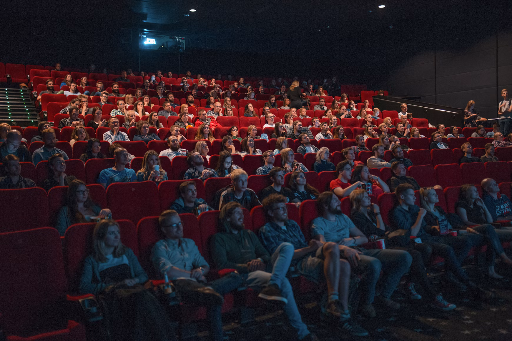 Movie theater audience watching a pre-show cinema ad