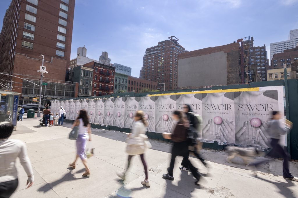 Wild Posting® posters for Savoir Beauty in New York City, displayed on a construction barricade at 72nd Street and 2nd Avenue, April 2025.