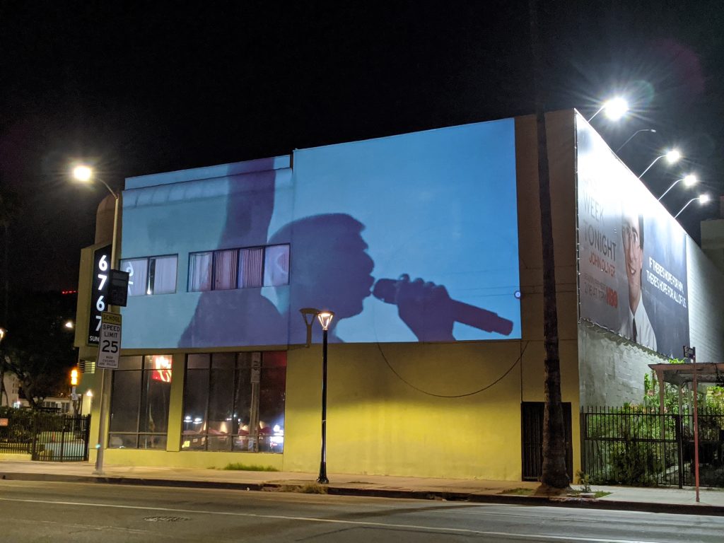 Large-scale building projection advertising campaign at night