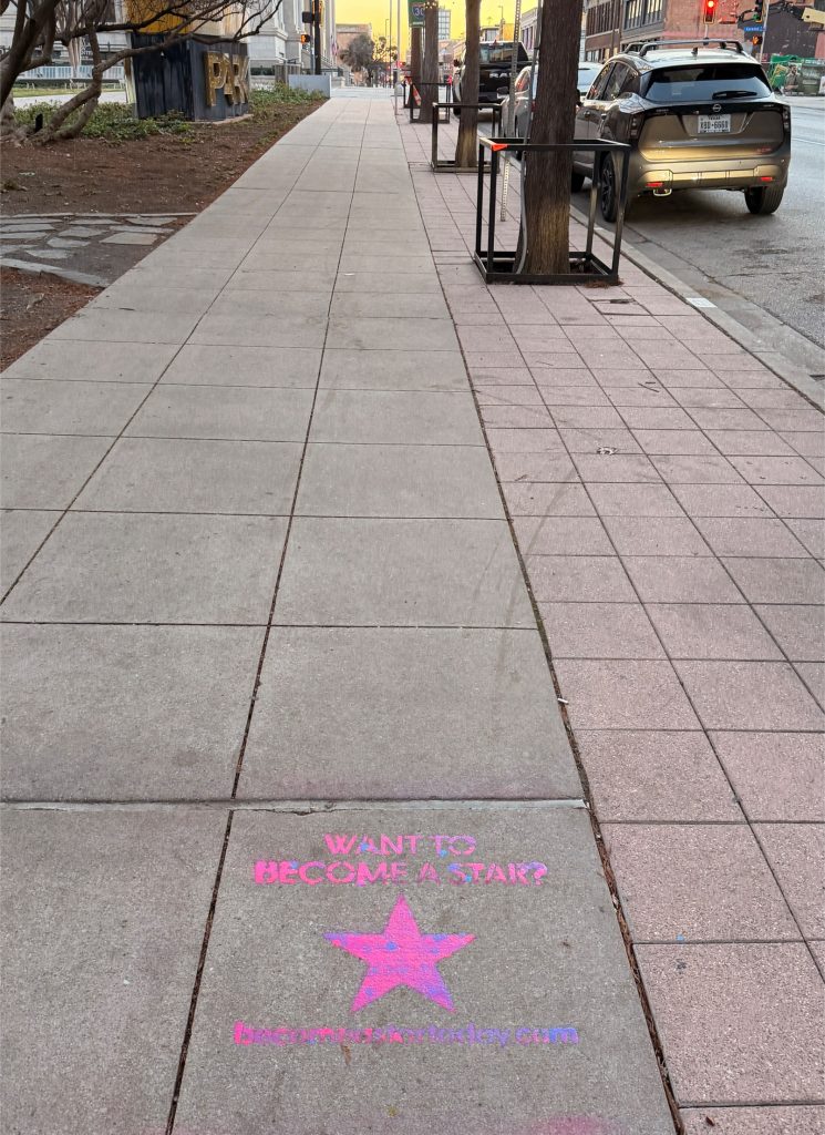 Chalk stencil advertisement on a Nashville sidewalk promoting becomeastartoday.com