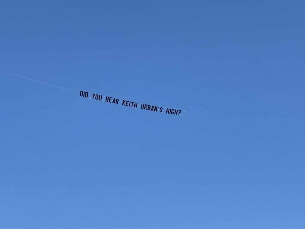 Aerial banner advertising campaign for Keith Urban's High flying over clear blue sky