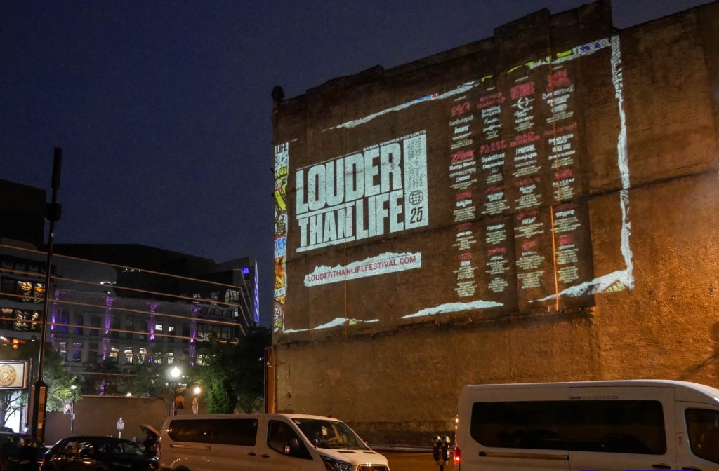 Wall projection advertising campaign on a building facade at night
