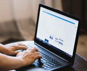 Person managing search engine marketing campaign on laptop