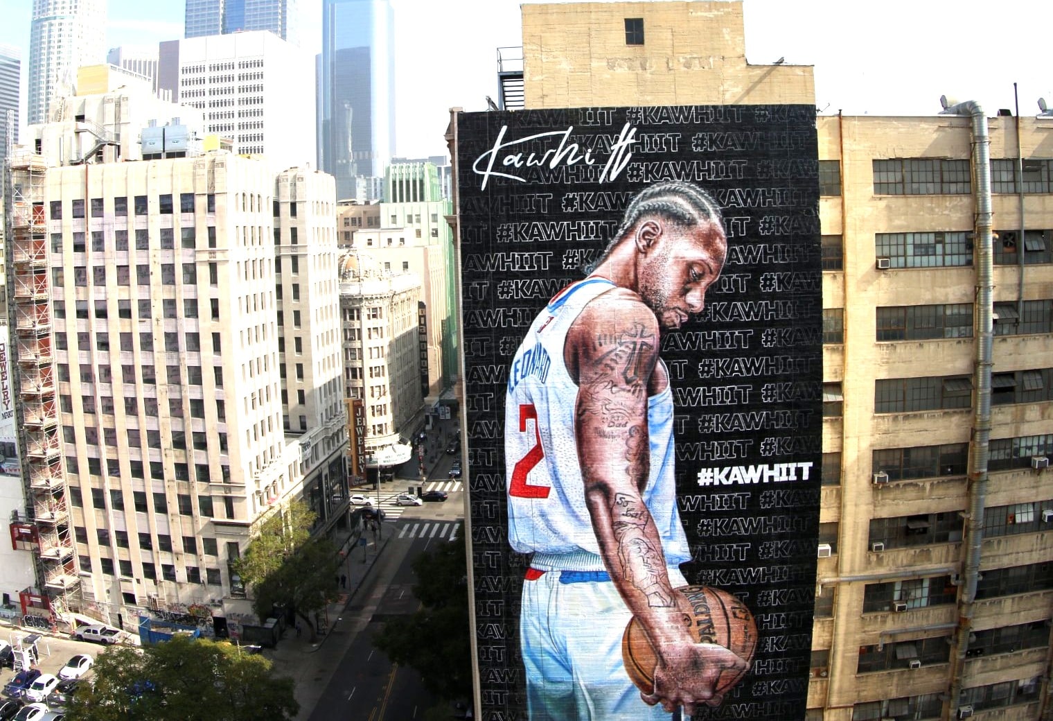 Kawhi Leonard wallscape advertisement on a building in downtown Los Angeles with the city skyline in the background