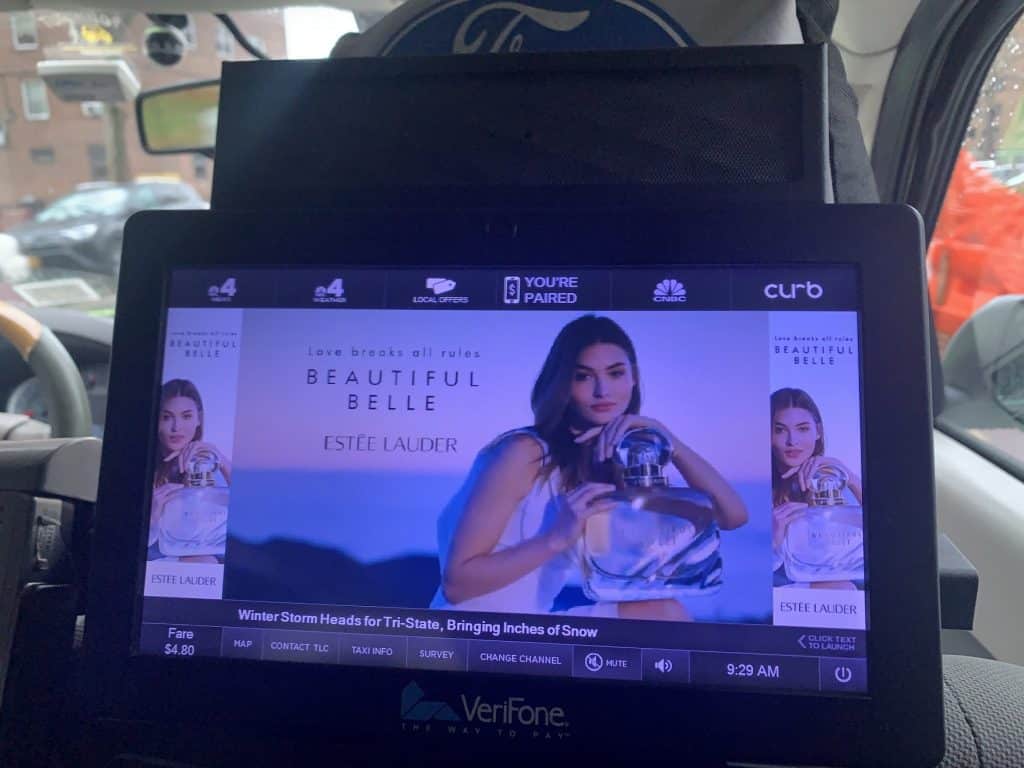 Estée Lauder ad on a taxi interior screen in New York City