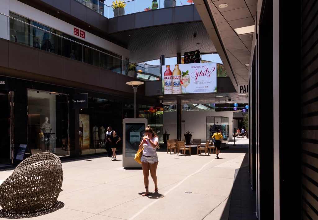 Digital display ad for Lillet in an outdoor shopping mall corridor in Los Angeles