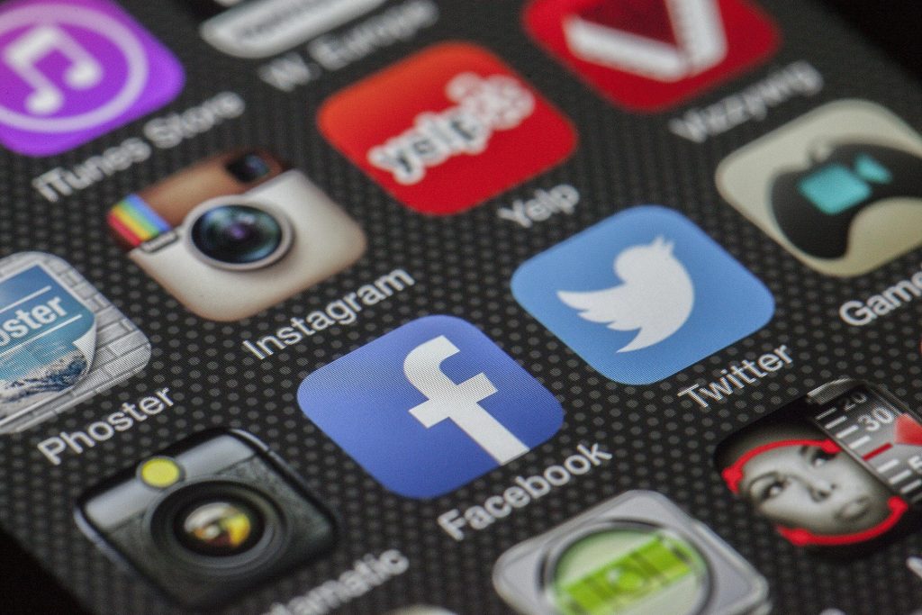 Social media advertising apps on iPhone including Instagram, Facebook, and Twitter