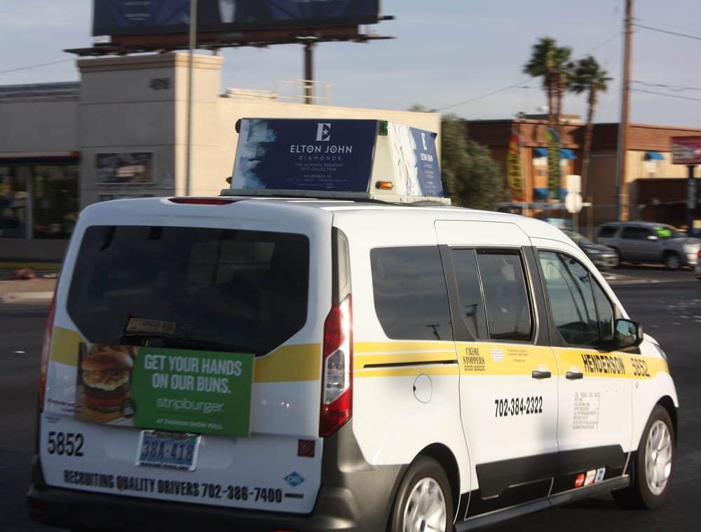 Las Vegas taxi cab with Elton John rooftop display and Stripburger trunk ad