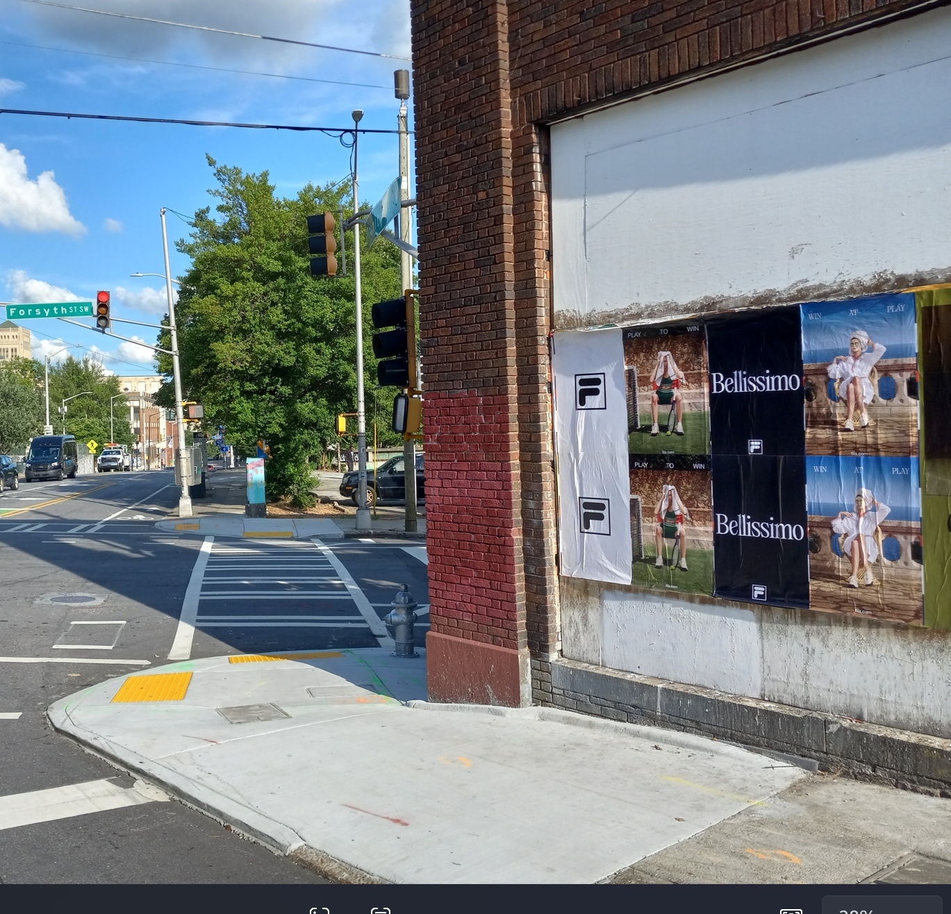 FILA "Bellissimo" and "Win at Play" Wild Posting® and wheat pasting campaign on a brick corner wall at Forsyth St SW in Downtown Atlanta, repeating editorial poster takeover