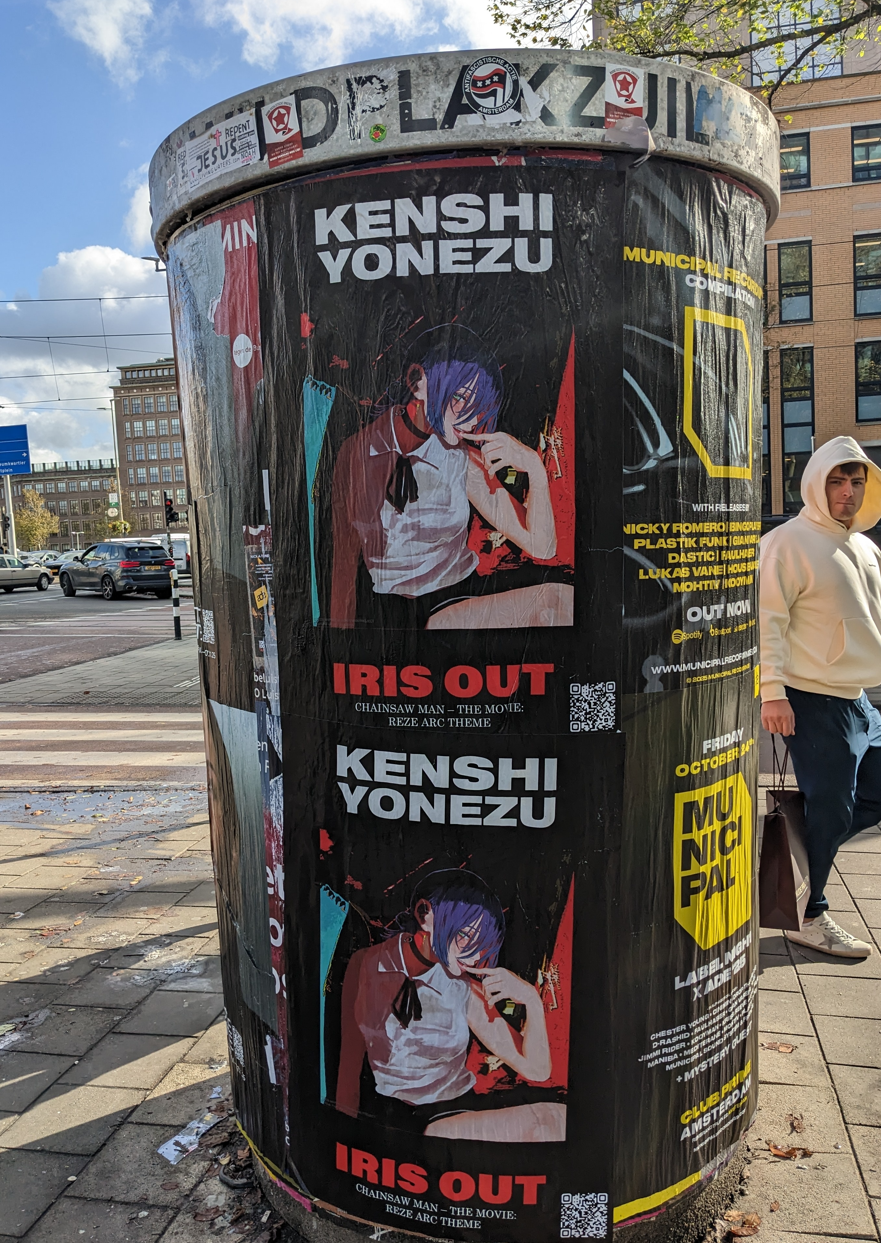 Kenshi Yonezu "Iris Out" Wild Posting® campaign on an Amsterdam plakzuil, installed by DASH TWO for Sony Music — promoting the Chainsaw Man – The Movie: Reze Arc theme song.