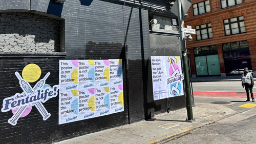 Wild Posting® campaign for Fentalife harm reduction nonprofit featuring "This poster is not the problem" and "We love Narcan" messaging installed on urban street wall