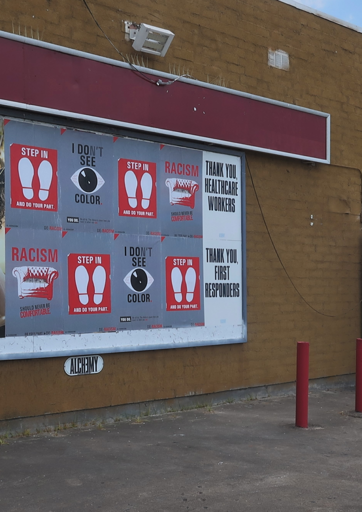 Wild Posting® campaign in Houston for the De-Racism Foundation — anti-racism PSA posters and COVID-era healthcare worker and first responder tribute panels wheat-pasted at N Main Street and Airline Drive in Near Northside / Independence Heights