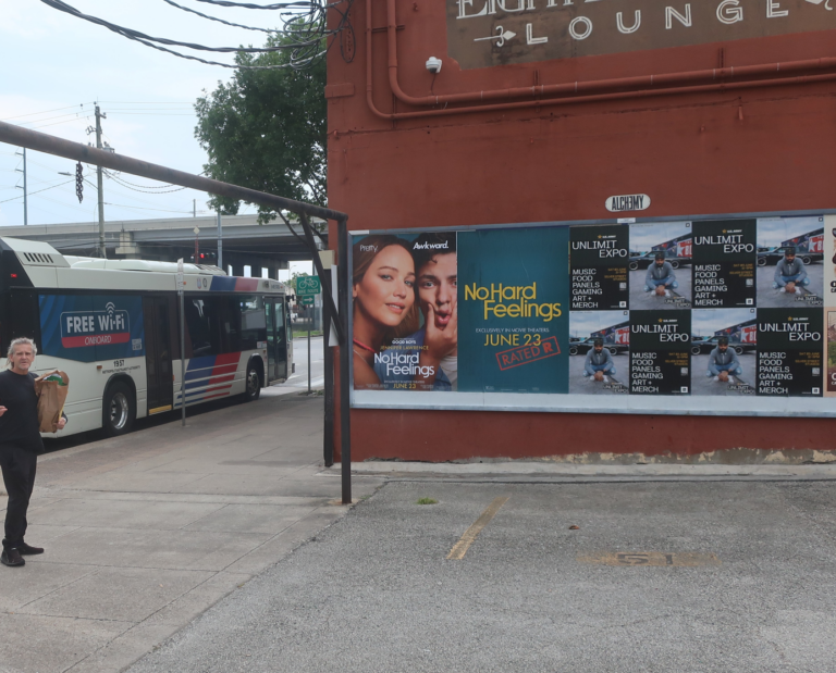 Wild Posting® campaign in Houston for the U.S. Army "Unlimit Expo" event at Silver Street Studios — wheat-pasted poster grid along a METRO bus corridor