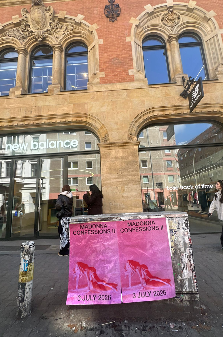 Madonna Confessions II tour wheat pasting posters in Berlin Mitte, installed on a utility box outside the New Balance flagship near Hackescher Markt — Wild Posting® campaign by DASH TWO