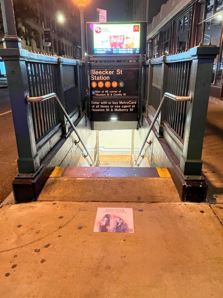 Goose Dripfield album sidewalk decal advertising campaign at Bleecker Street subway station entrance in New York