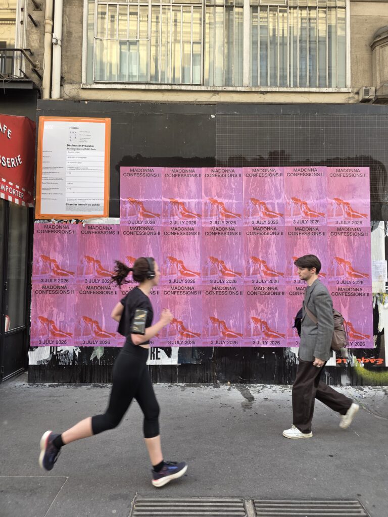Wild Posting and wheat pasting in Paris — Madonna "Confessions II" 3 July 2026 tour announcement 12-panel takeover on a permitted palissade de chantier at 25 rue du Louvre, Paris 1st arrondissement, installed beside the building's Déclaration Préalable permit notice, by DASH TWO